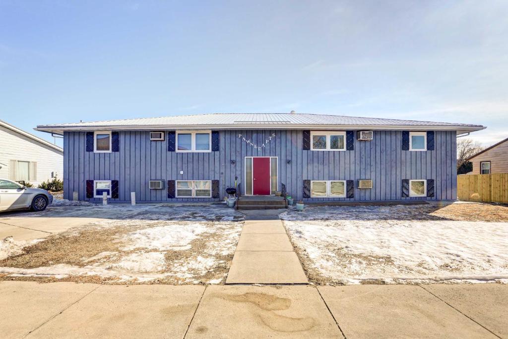 a blue house with a red door at Pierre Vacation Rental - 9 Mi to Oahe Dam! in Pierre