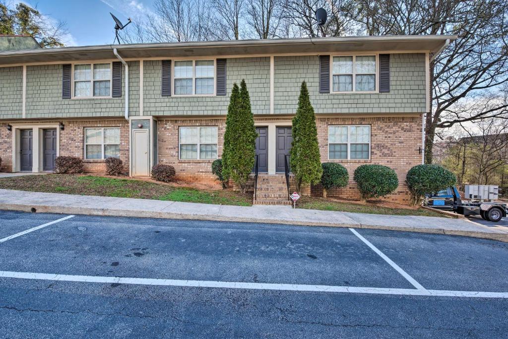 a house with a parking lot in front of it at Smyrna Townhome, Close to Truist Park! in Smyrna