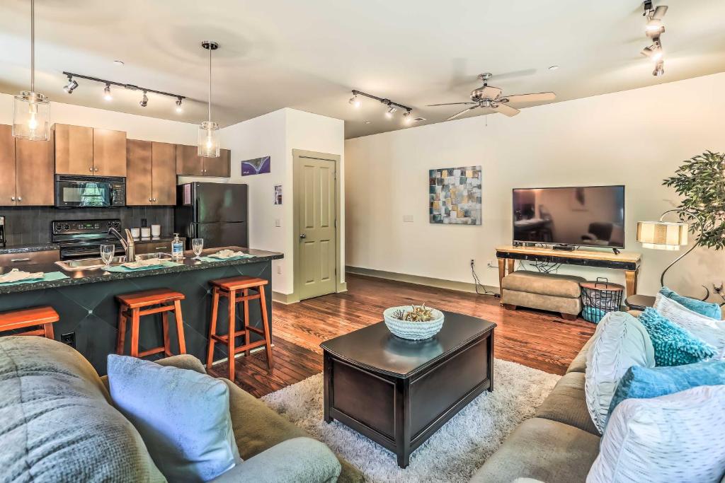 a living room with a couch and a kitchen and a table at Dwtn Condo 4 Blocks to The Wilmington Riverwalk! in Wilmington