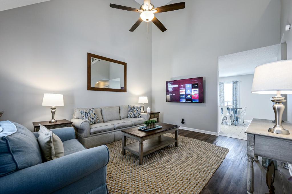 a living room with a couch and a tv at Welcome To This 4BR Getaway Near LakePoint Sports in Cartersville