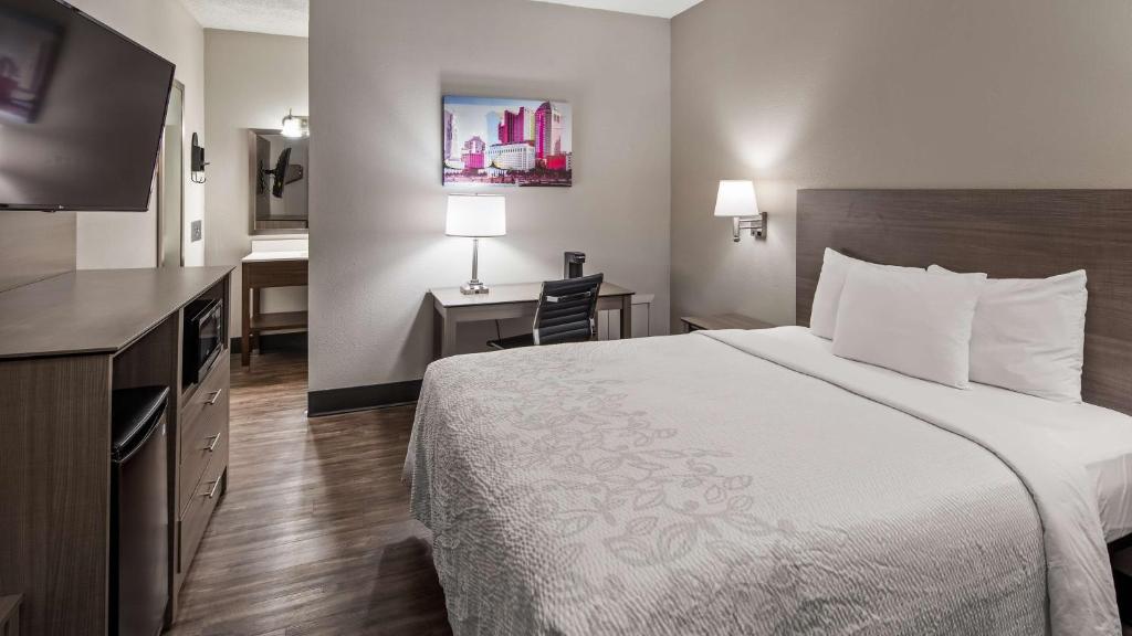 a hotel room with a large bed and a desk at SureStay Hotel by Best Western Findlay in Findlay