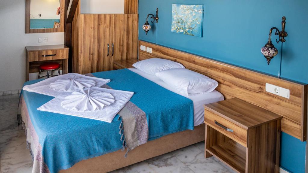 Postel nebo postele na pokoji v ubytování Loya Vita Hotel