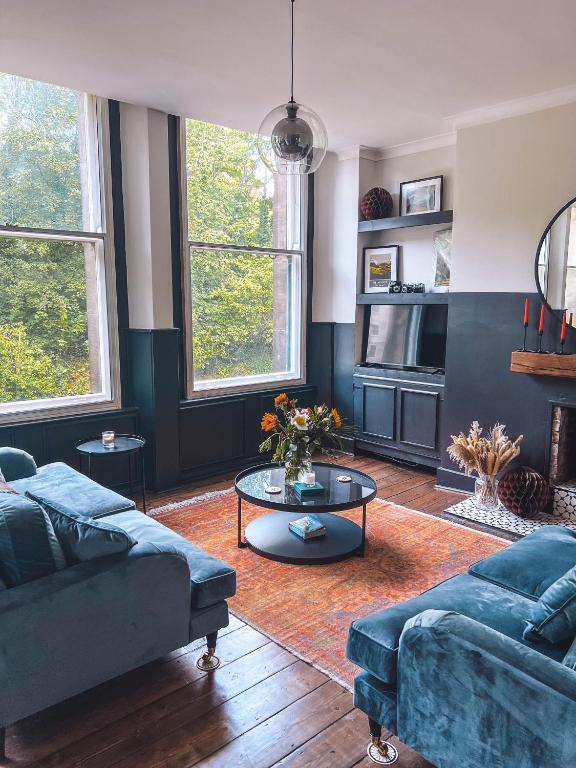 a living room with two couches and a table at Luxury Apartment in the heart of Newcastle centre in Newcastle upon Tyne