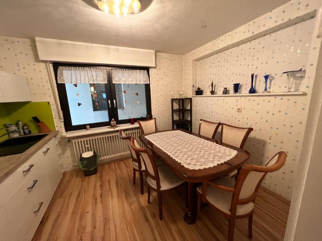 a kitchen with a table and chairs in a room at Apartment Colonia in Cologne