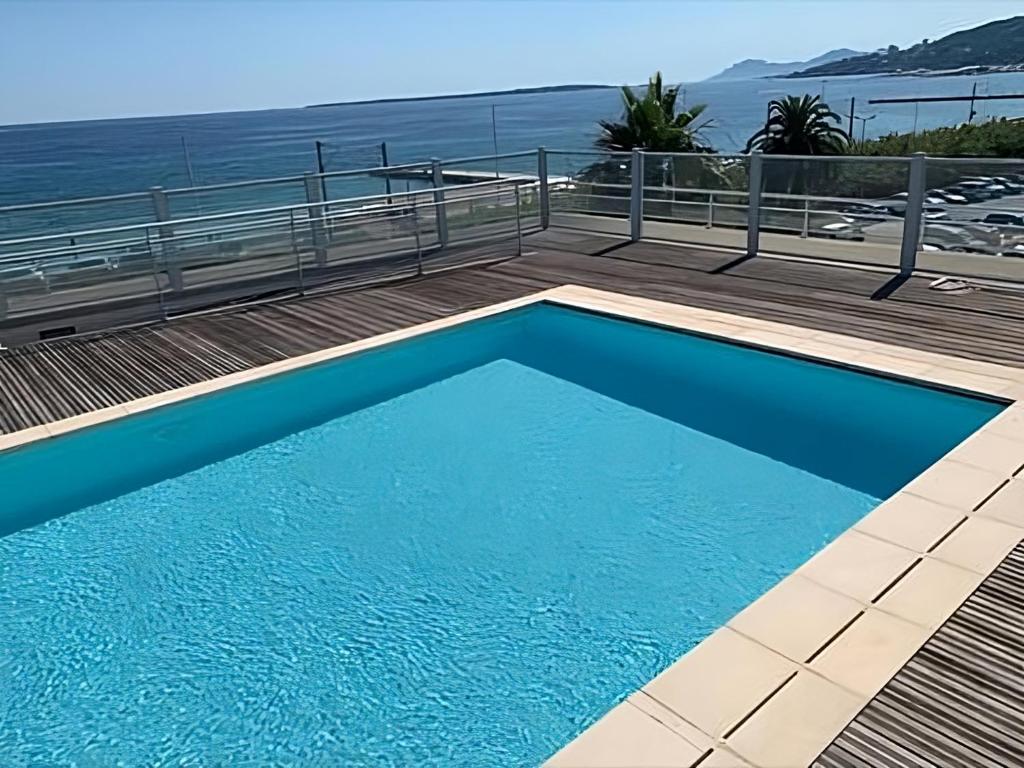 a swimming pool with a view of the ocean at Rooftop pool, private garden, at the sand beach! in Antibes