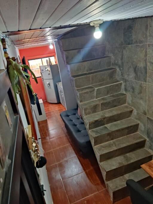 una escalera en una habitación con una pared de ladrillo en Apartamento Cómodo y Familiar, en Medellín