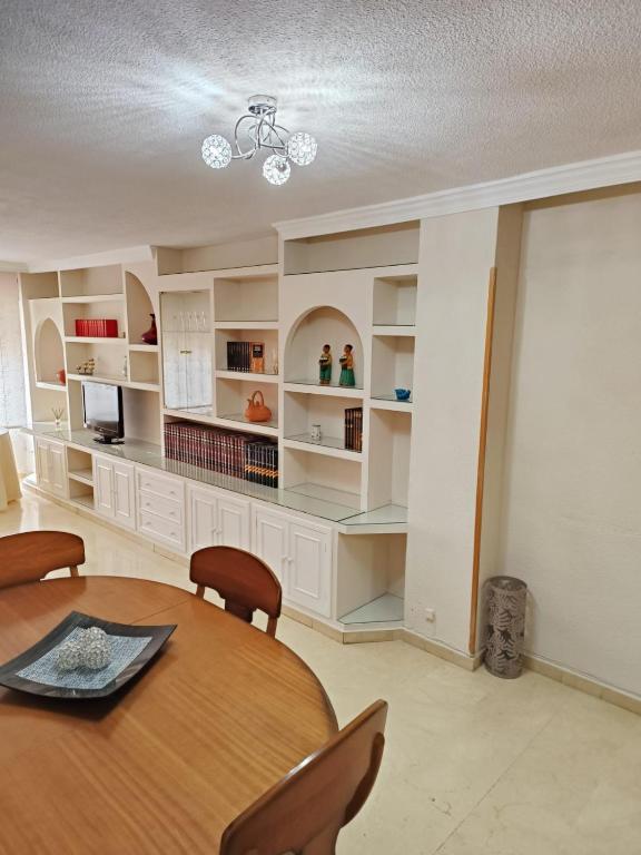 格拉納達的住宿－PISO EL SERRALLO，一间带桌子和一些书架的用餐室
