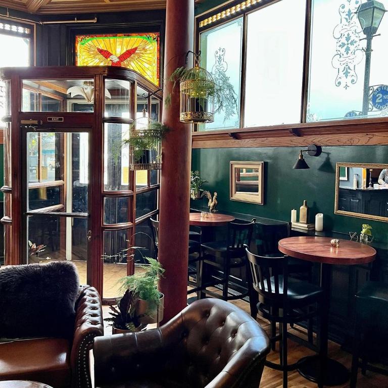 a restaurant with tables and chairs and windows at The Inn at 2nd & C in Eureka