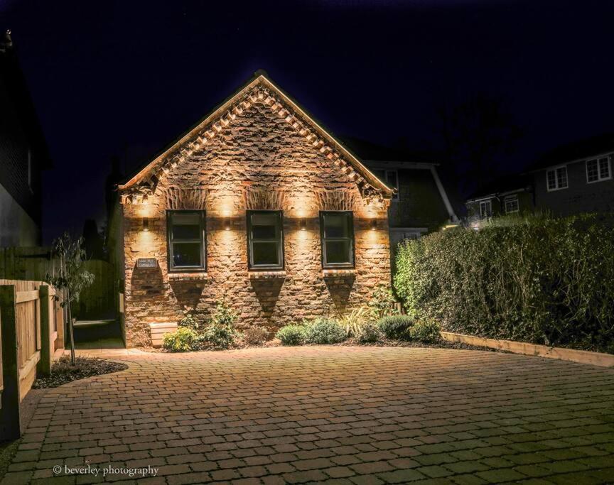 a brick house with lights on the front of it at Molehill Cottage - New 2023 - EV Charger - Pets in Beverley