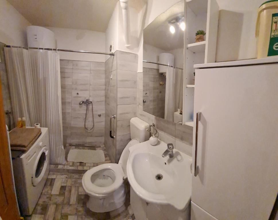 a small bathroom with a toilet and a sink at Kineski zid in Zenica