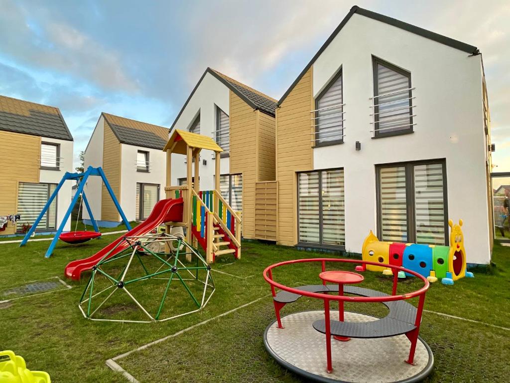 a playground in front of a house at Sun-Holiday Domki letniskowe in Rewal