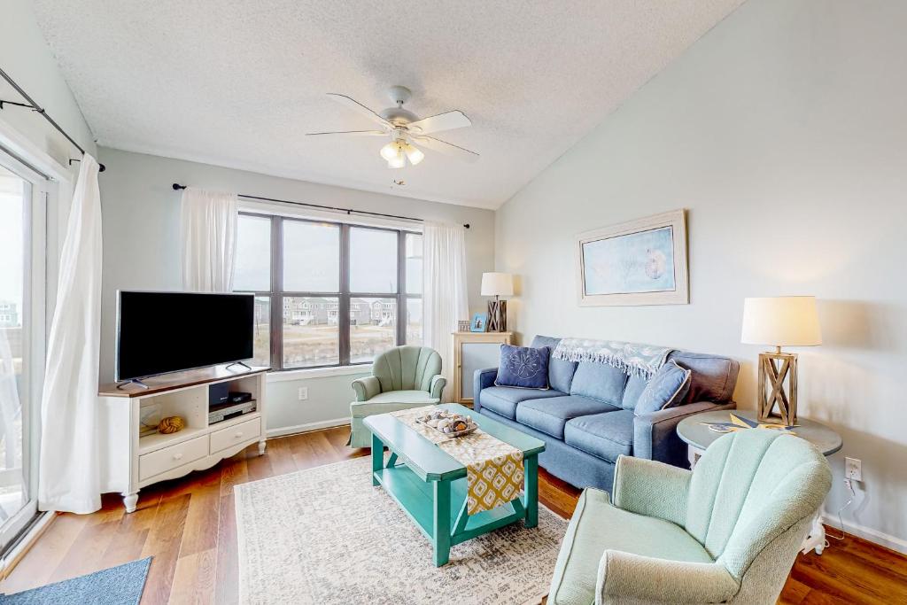 a living room with a blue couch and a tv at High View in Avon