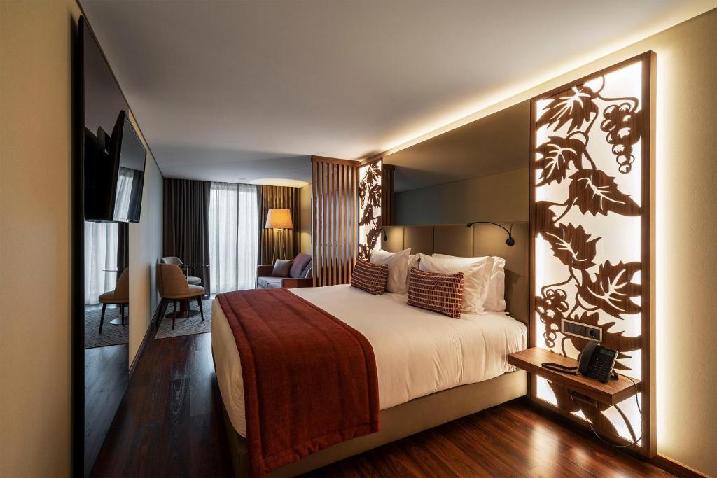 una habitación de hotel con una cama grande en una habitación en TURIM Oporto Hotel, en Oporto