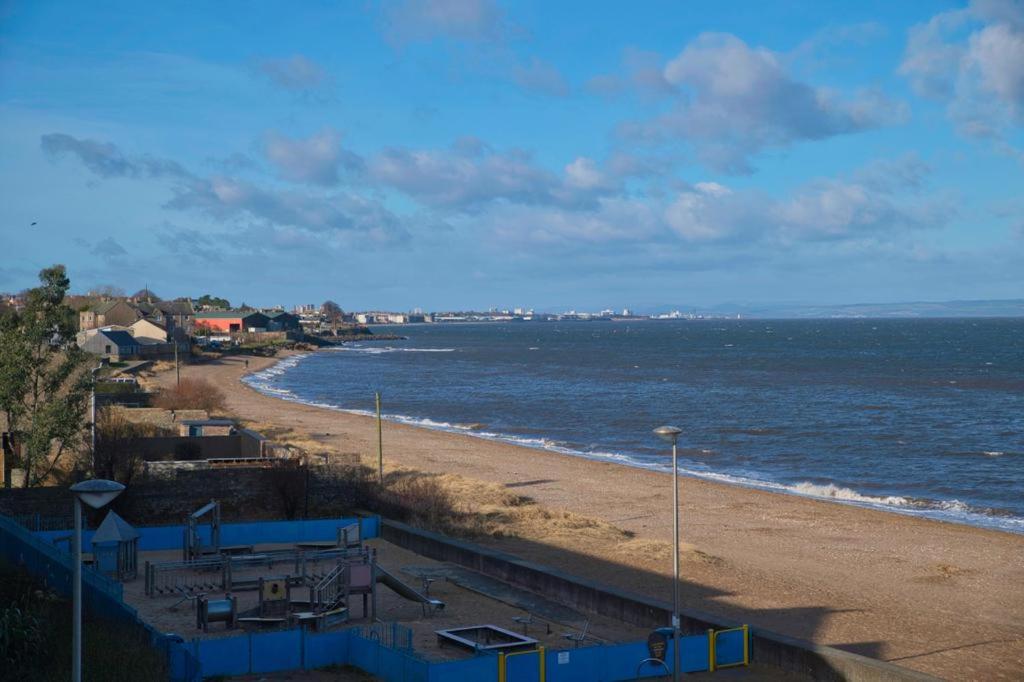 a beach with a view of the ocean at Stunning 3 bed seaview apartment in Musselburgh