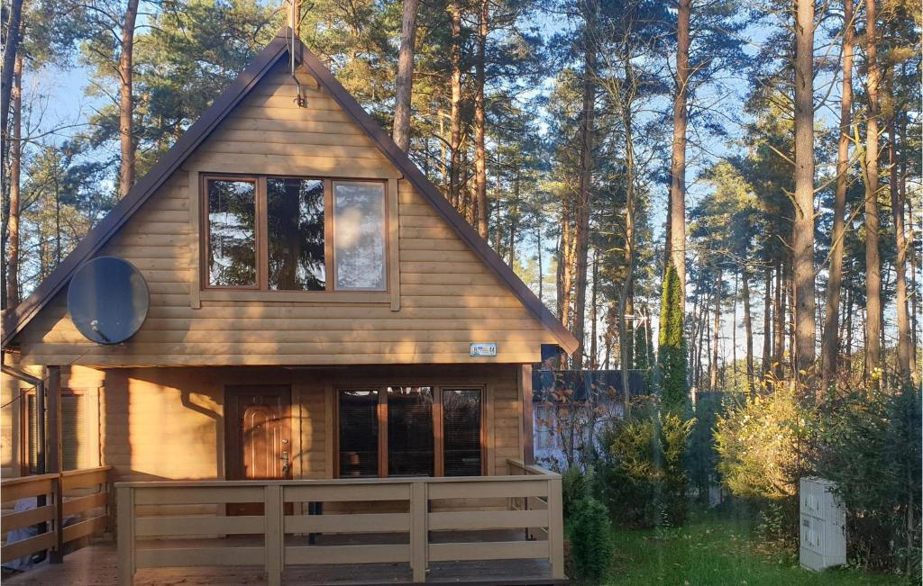 a tiny house in the woods with trees in the background at Awesome Home In Ostrda With House Sea View in Ostróda