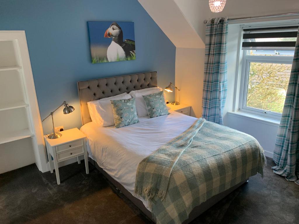 a bedroom with a bed and a window at Burnbank BnB in Tobermory
