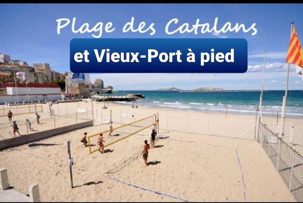 a group of people playing volleyball on a beach at Studio coin nuit, Entre plage et centre in Marseille