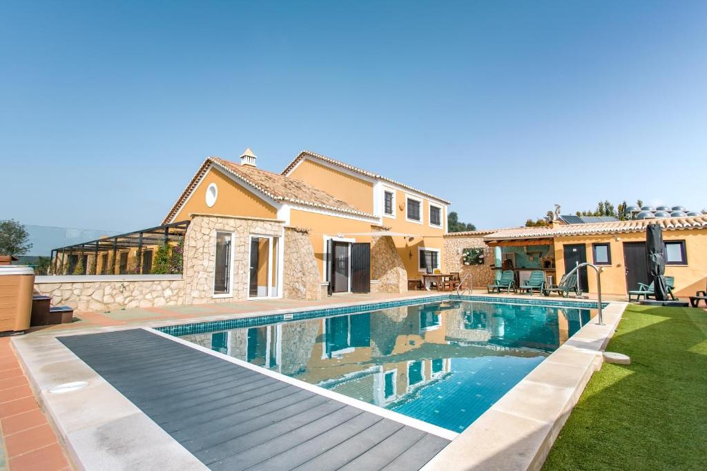 a swimming pool in the backyard of a house at Villa Casa Velha in Portimão