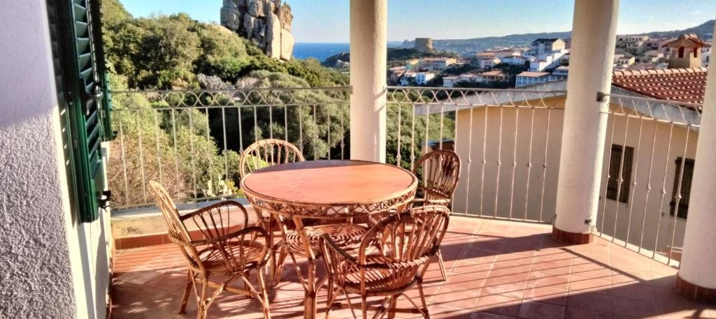 a table and chairs on a balcony with a view at Alba Chiara Sea View in Santa Teresa Gallura