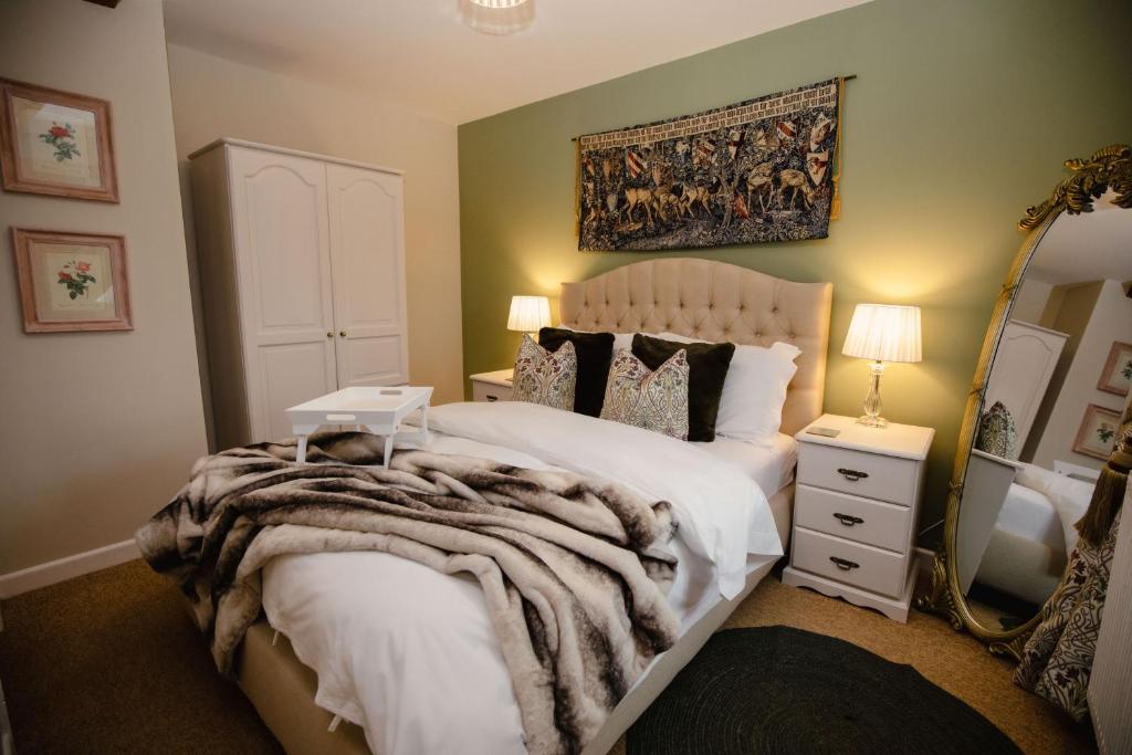 a bedroom with a bed with a dog laying on it at Pigsty Cottage - Rudge Farm Cottages in Bridport