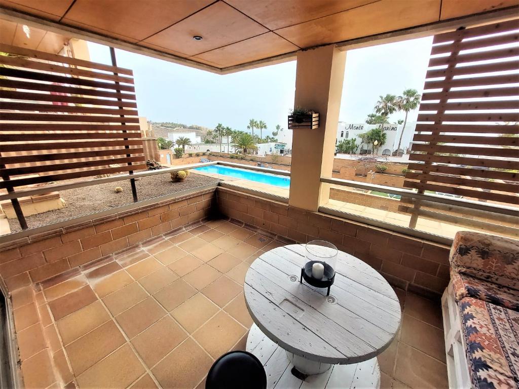 a patio with a table and a swimming pool at Casa El Secreto in Playa Jandia