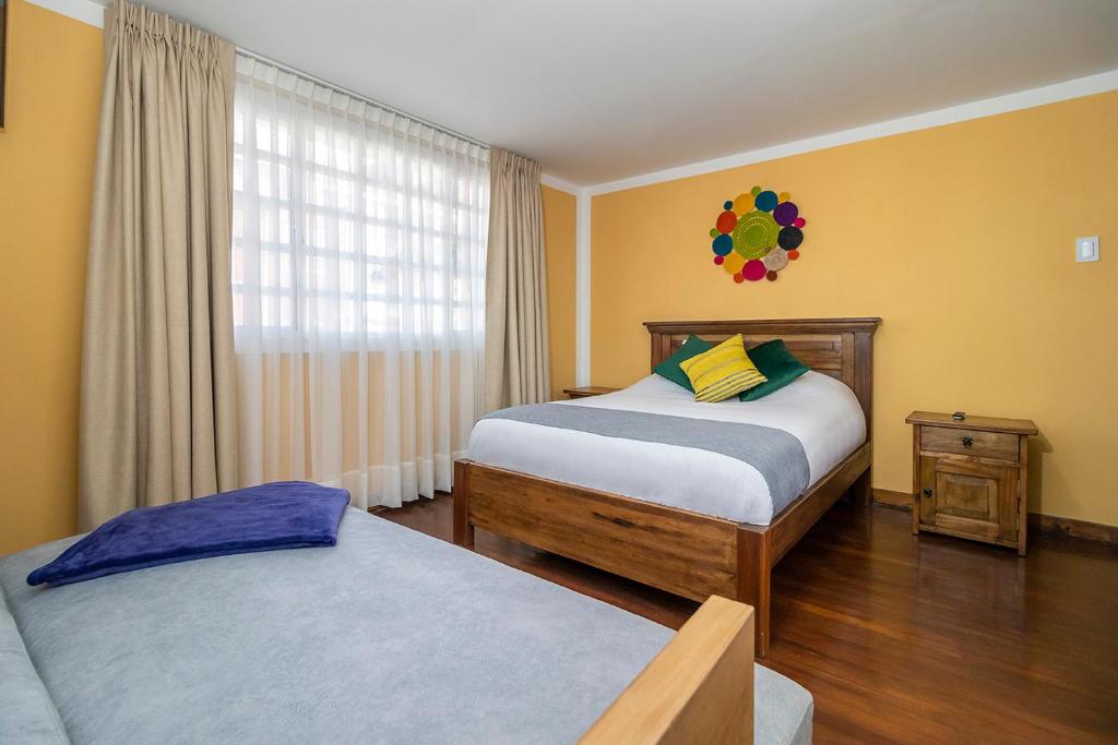 Postel nebo postele na pokoji v ubytování Corazon del Molino Corferias Bogota- Embajada Americana