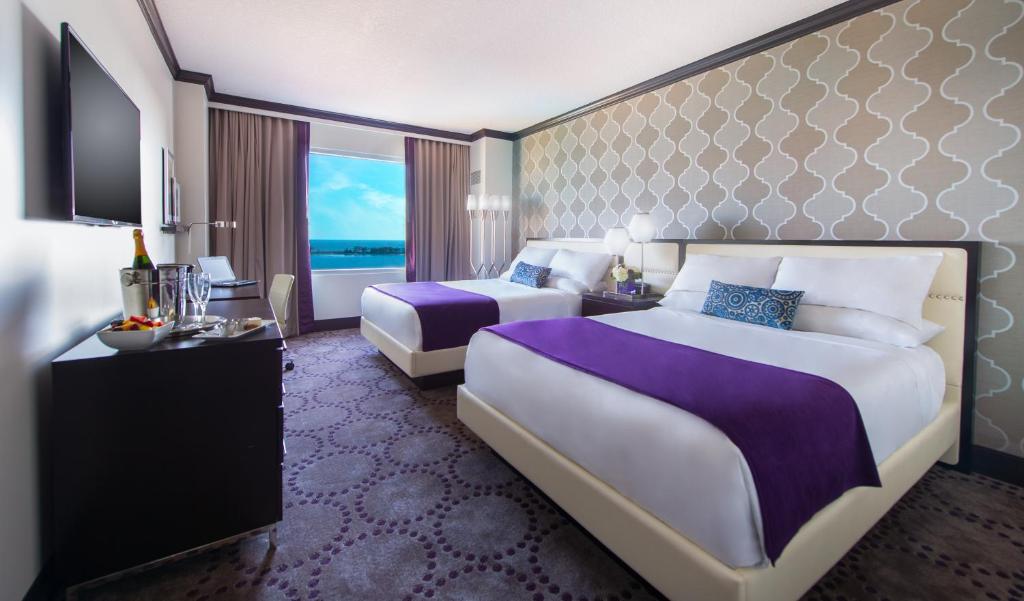 a hotel room with two beds and a large window at Beautiful Unit in Harrah's Casino Strip LAS VEGAS in Las Vegas