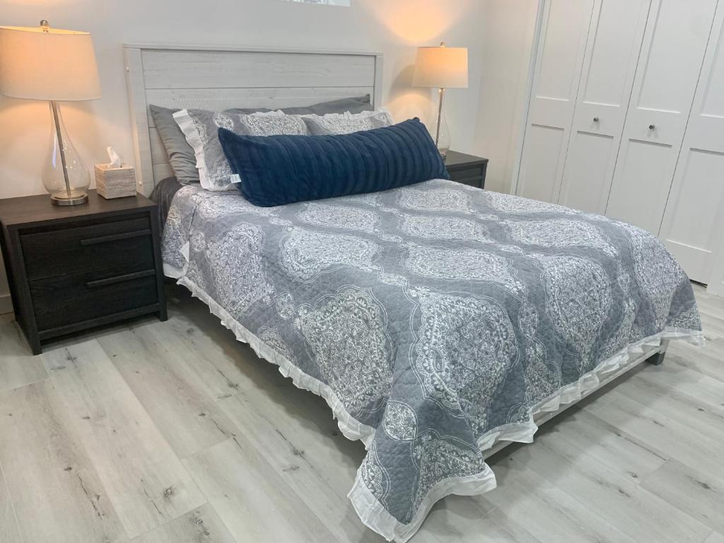 a bedroom with a bed with a blue and white comforter at Best location in Charming Downtown Ballard! Rare Find! in Seattle