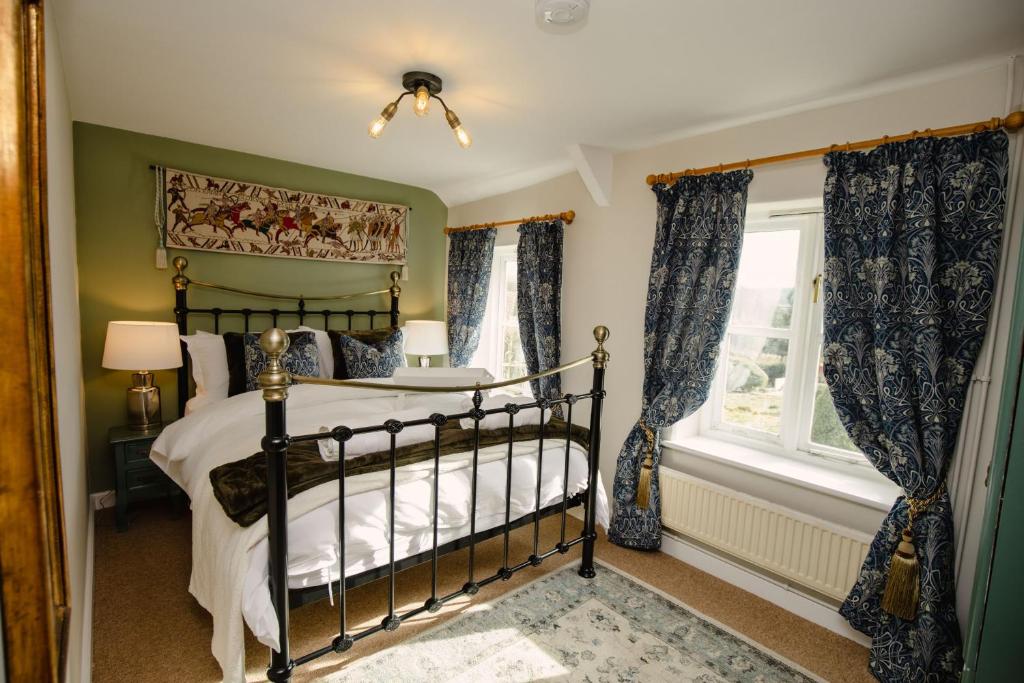 a bedroom with a bed and a window at Keepers Cottage - Rudge Farm Cottages in Bridport