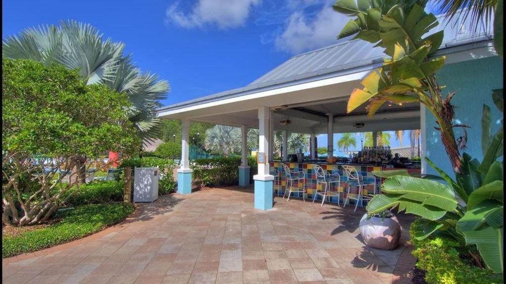 a patio with chairs under a pavilion at Holiday Inn Express & Suites S Lake Buena Vista by IHG in Kissimmee