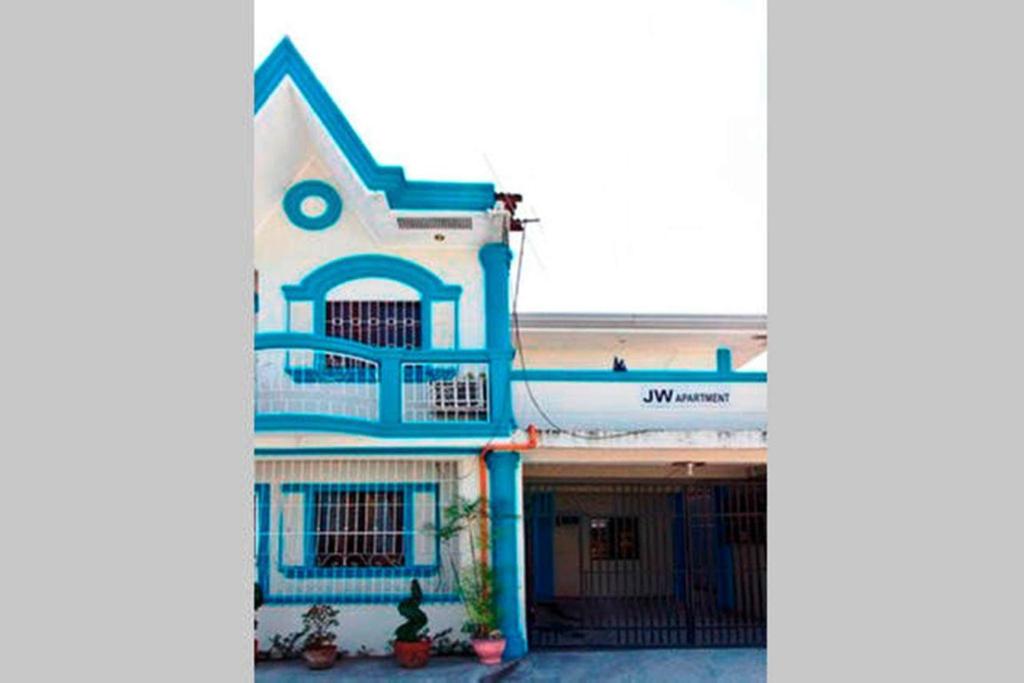 a blue and white building with a building at JW Apartments in Angeles