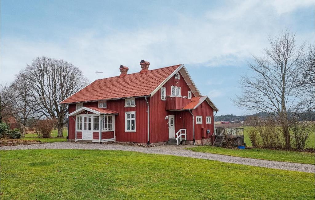 a red house with a red roof on a field at 5 Bedroom Pet Friendly Home In Sollebrunn in Sollebrunn