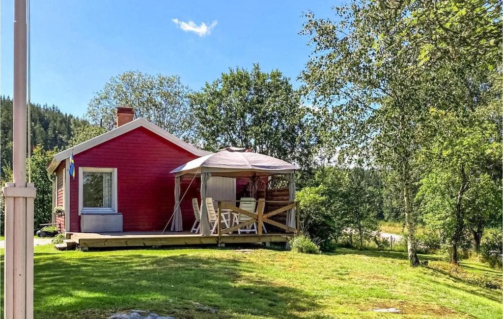 a red house with a gazebo in a yard at Stunning Home In Bullaren With 1 Bedrooms in Bullaren