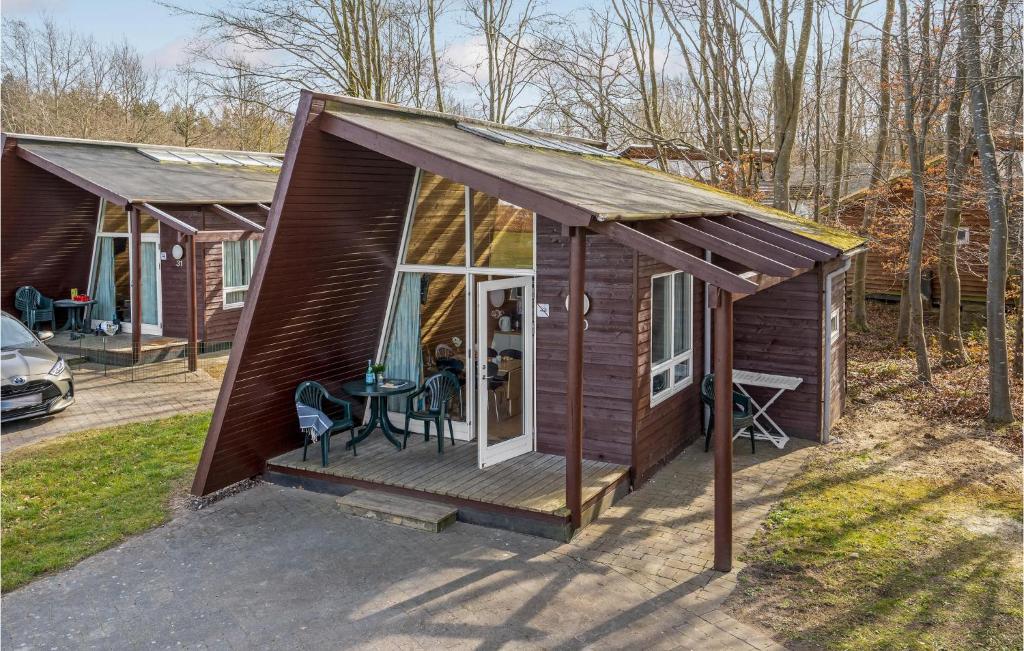 a small cabin with a deck and a table at 2 Bedroom Awesome Home In Fredericia in Fredericia