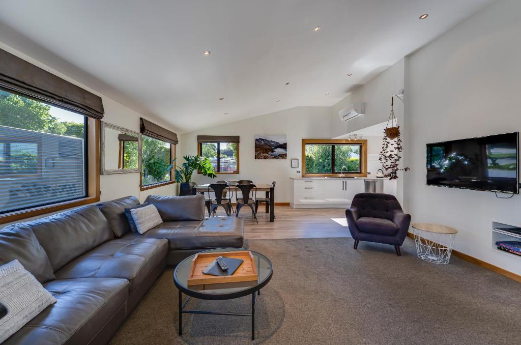 a living room with a couch and a table at Remarkable View 4 Bedroom in Queenstown