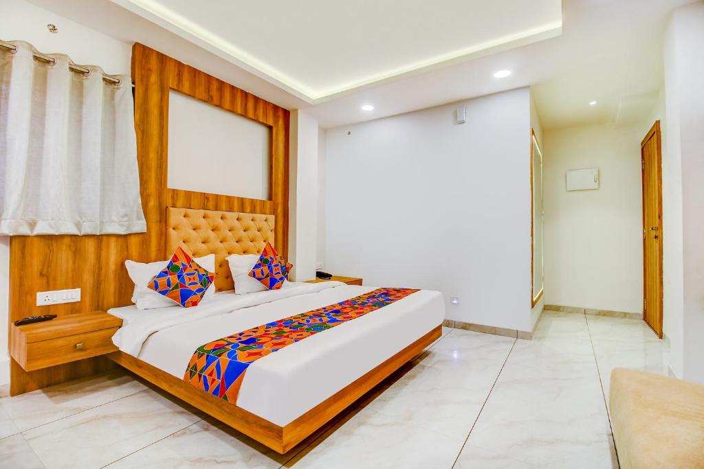a bedroom with a large bed in a room at FabHotel Prime Purple Orchid in Bhopal