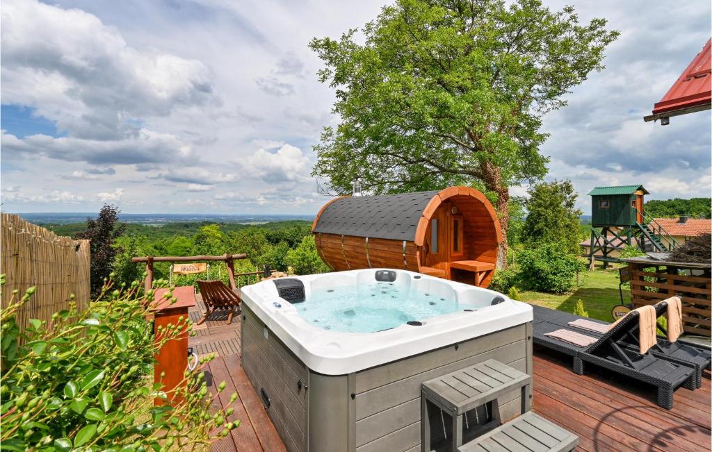 a hot tub on top of a patio with a tree at Lovely Home In Beletinec With Wifi in Beretinec