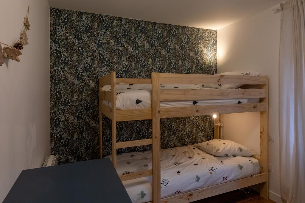 Posteľ alebo postele v izbe v ubytovaní Les appartements de Clélia