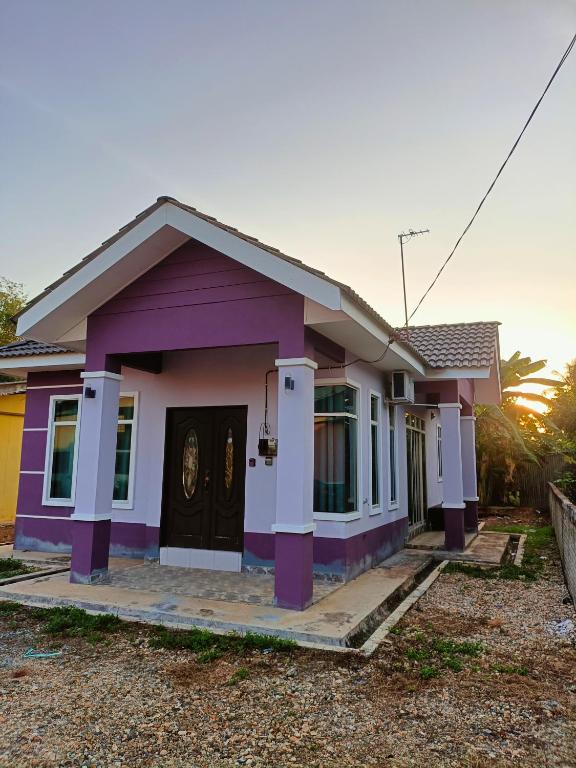 a small house with a purple at NazLa Homestay Pendang in Pendang