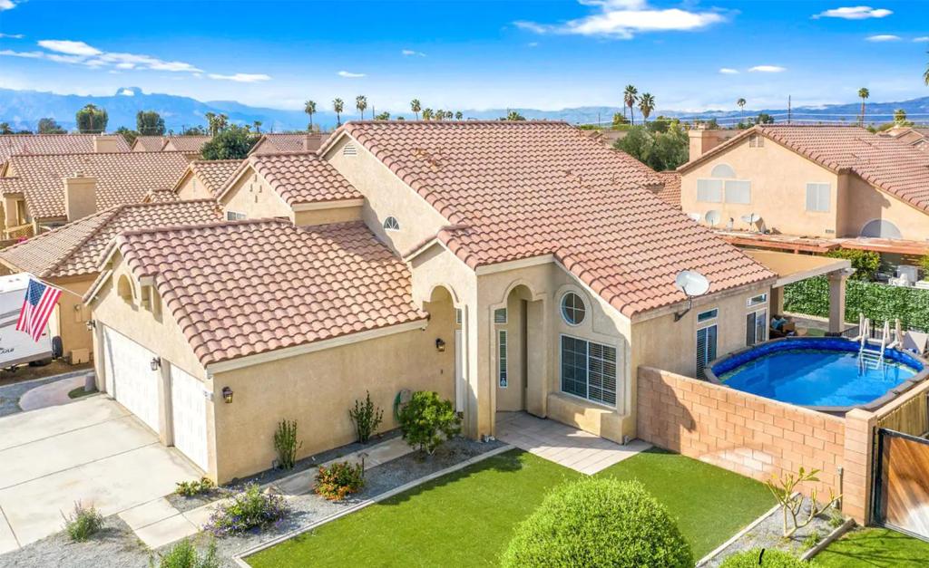 an aerial view of a house with a swimming pool at Golden Desert Getaway Family Friendly Home in Indio