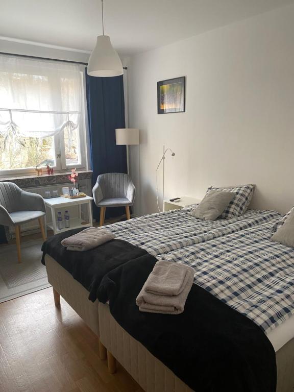 a bedroom with a bed with two towels on it at A&M in Nynäshamn