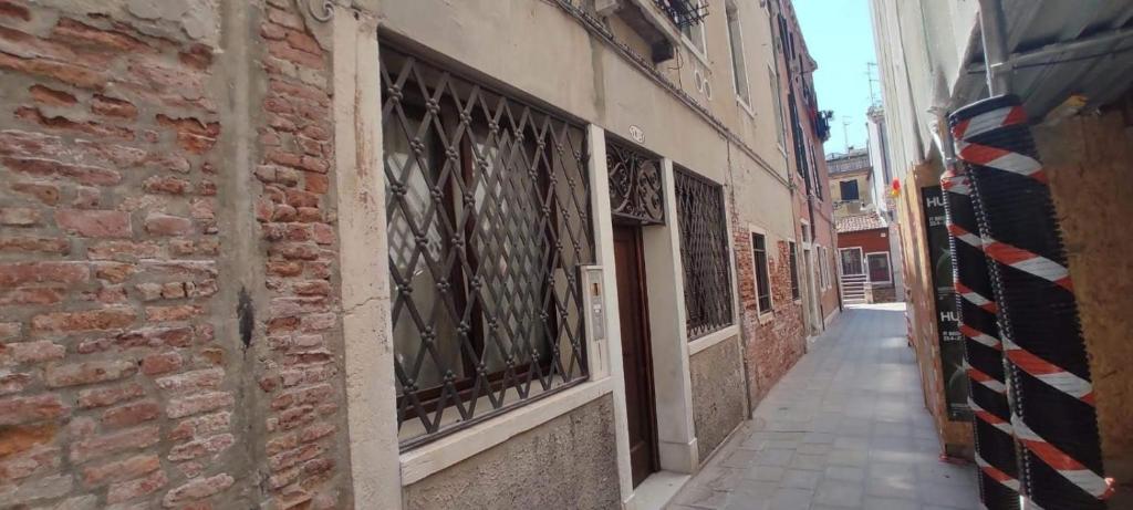 alejka w starym budynku z bramami z kutego żelaza w obiekcie Ca' Baby Venezia w Wenecji