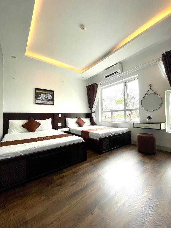 Postel nebo postele na pokoji v ubytování King Hotel Da Nang