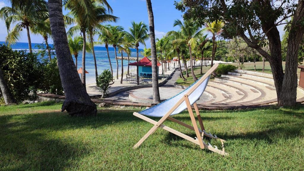 a slide in the grass next to a beach at Studio vue mer Guadeloupe in Sainte-Anne