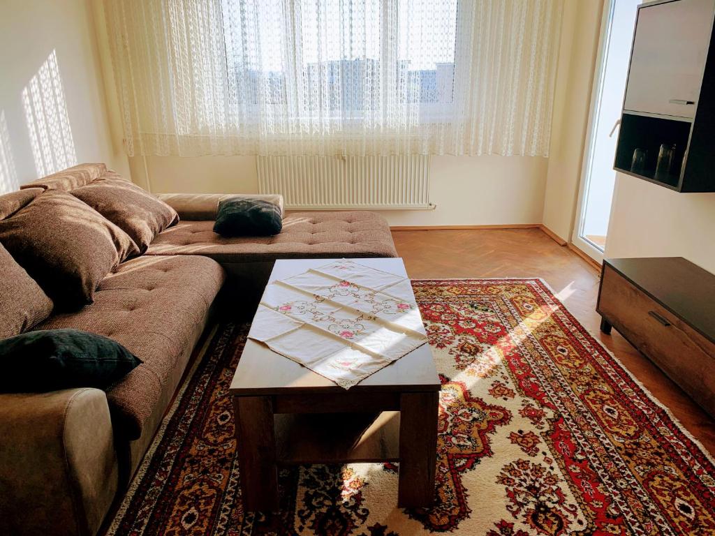 a living room with a couch and a coffee table at Flat 4you & WI-FI in Arad
