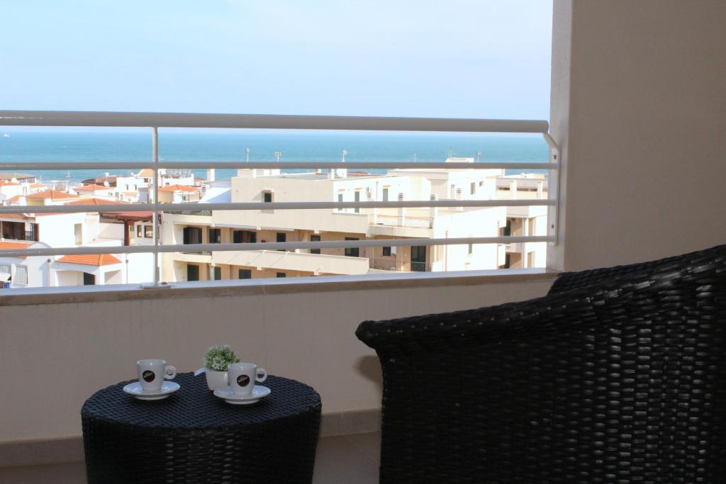 a balcony with a table and a view of a city at Navicri B&B in Vieste