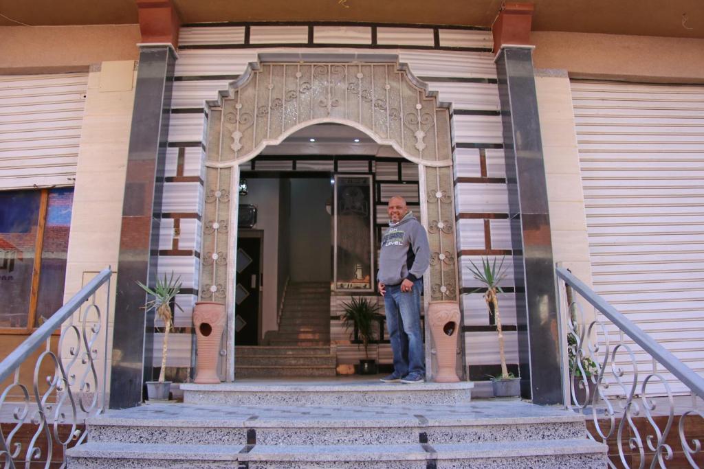 a man standing on the front porch of a house at Apartment im Al-Manar House Safaga in Hurghada