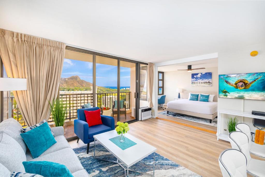 a living room with a couch and a bed at Fabulous Ocean & Diamond Head View with Free Parking! in Honolulu