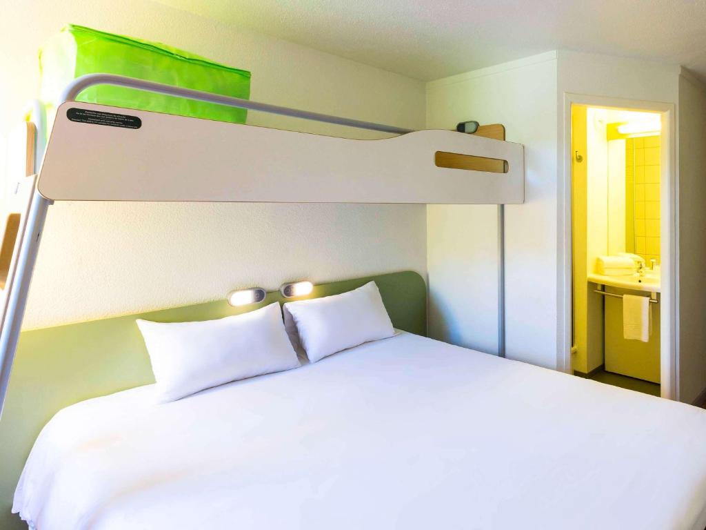 ベジエにあるIbis budget Béziers Est Mediterranée A9 / A75のベッドルーム1室(二段ベッド1組、白い枕2つ付)