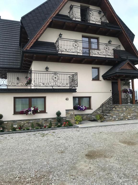 a house with balconies on the side of it at Osada Groń in Groń